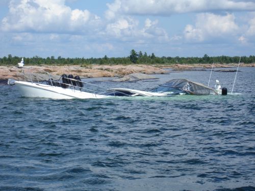 Boat holed in the bow sank aft where the engines are located.